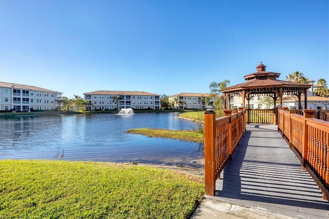 view of dock featuring a gazebo and a water view