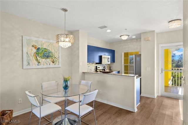2060 Willow Hammock Cir Unit 304, Punta Gorda, FL 33983 - dining area with wood finished floors, recessed lighting, and a chandelier