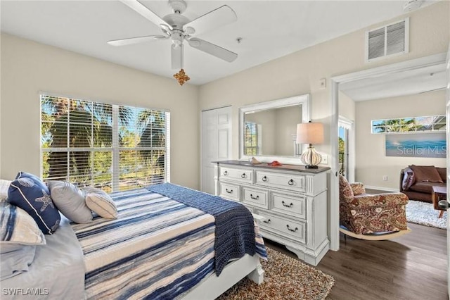 bedroom featuring hardwood / wood-style floors, ceiling fan, and a closet