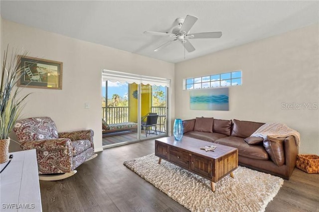 living room with ceiling fan, dark wood-type flooring, and a healthy amount of sunlight