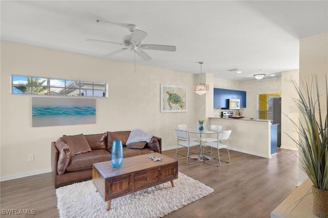 living room featuring hardwood / wood-style flooring and ceiling fan