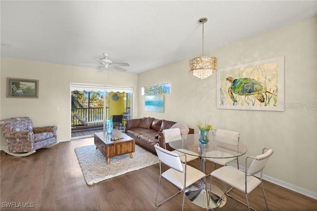 living room featuring dark hardwood / wood-style floors and ceiling fan