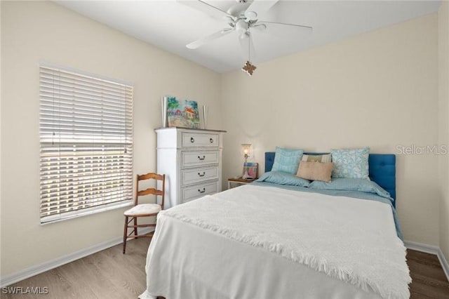 bedroom with ceiling fan and hardwood / wood-style floors