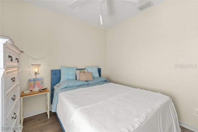 bedroom with ceiling fan and dark wood-type flooring