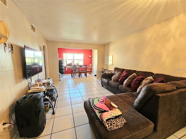 living room featuring light tile patterned floors and a textured ceiling