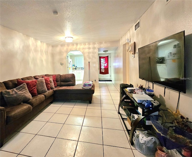 living room featuring light tile patterned floors and a textured ceiling