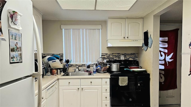 kitchen with decorative backsplash, white cabinetry, white appliances, and sink