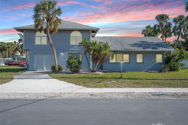 view of front of home featuring a yard and a carport