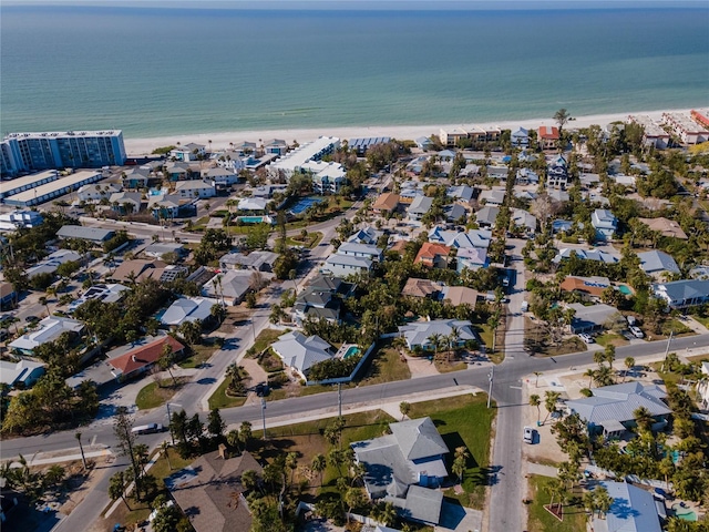 bird's eye view featuring a water view and a beach view