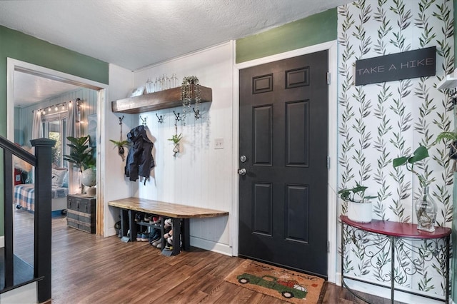 mudroom featuring a textured ceiling and dark hardwood / wood-style flooring