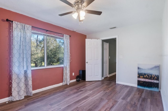 unfurnished bedroom with ceiling fan and hardwood / wood-style flooring