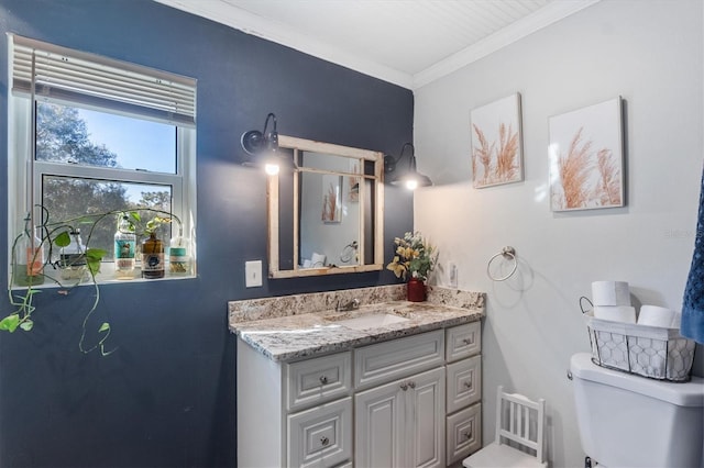 bathroom with vanity, toilet, and ornamental molding