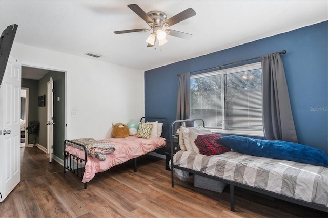 bedroom with hardwood / wood-style floors and ceiling fan