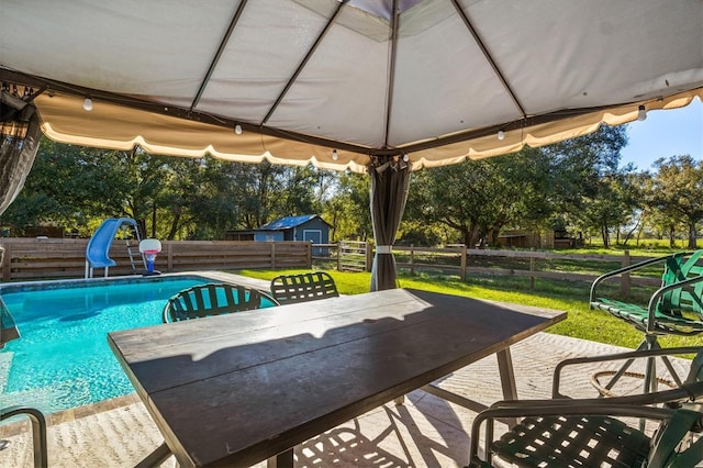 view of pool featuring a yard and a water slide