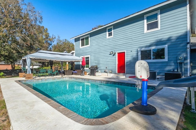 view of swimming pool with a gazebo, a grill, a patio, and central AC