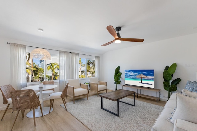 living room with ceiling fan and light hardwood / wood-style flooring