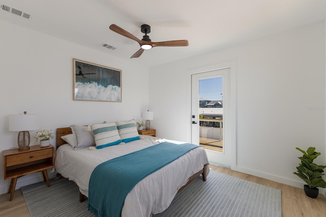 bedroom featuring access to exterior, light hardwood / wood-style flooring, and ceiling fan