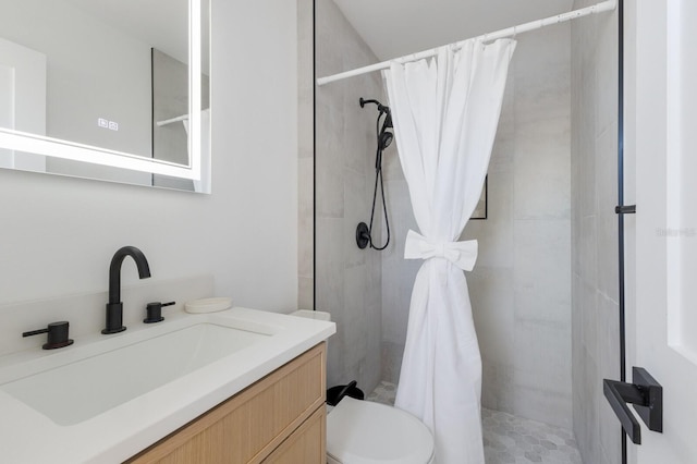 bathroom with toilet, vanity, and a shower with shower curtain