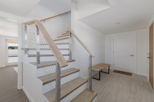 staircase featuring wood-type flooring