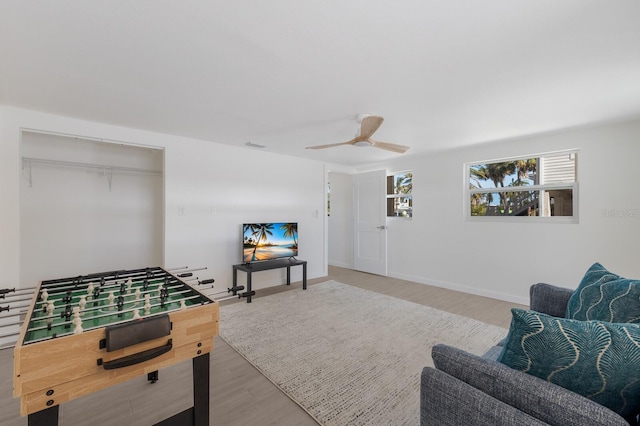 living room with ceiling fan and wood-type flooring