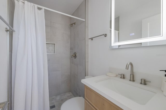 bathroom with a shower with curtain, vanity, and toilet