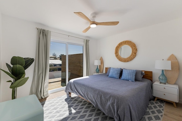 bedroom with access to exterior, light hardwood / wood-style floors, and ceiling fan