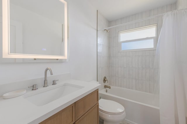 full bathroom featuring vanity, shower / bath combination with curtain, and toilet