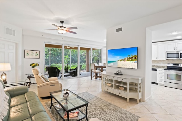 living room with ceiling fan and light tile patterned flooring