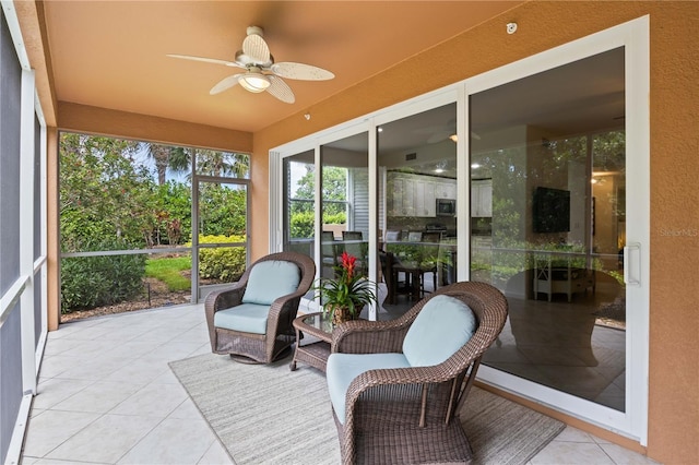 sunroom featuring ceiling fan