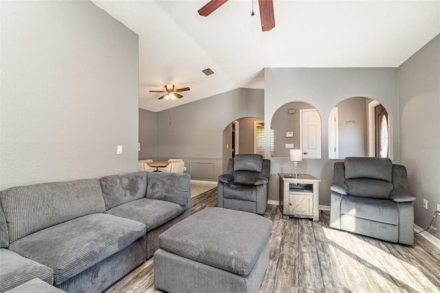 living room with wood-type flooring and lofted ceiling