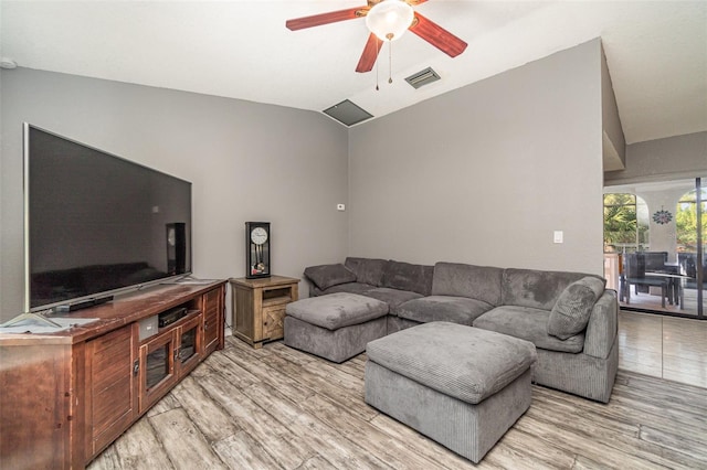 living room with ceiling fan, lofted ceiling, and light wood-type flooring