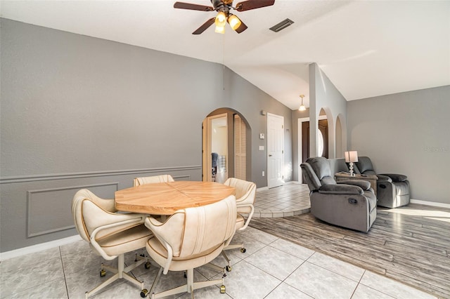 dining room featuring ceiling fan, lofted ceiling, and light wood-type flooring