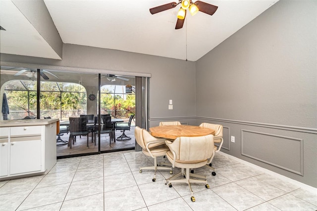 tiled dining space featuring lofted ceiling