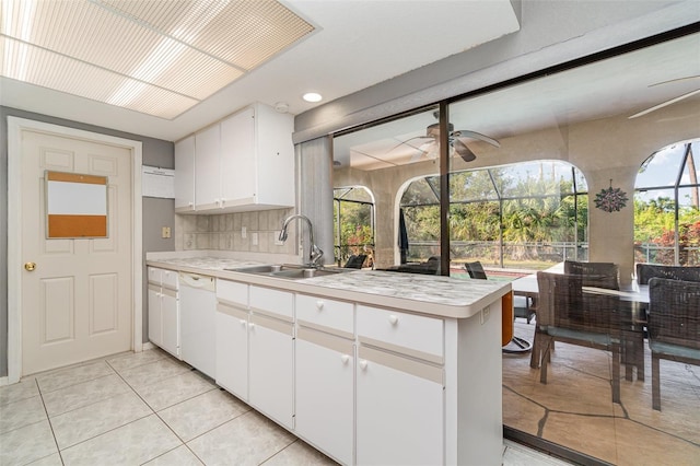 kitchen with white cabinetry, a wealth of natural light, sink, and white dishwasher