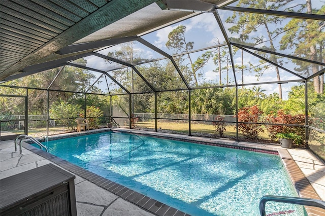 view of swimming pool with glass enclosure and a patio