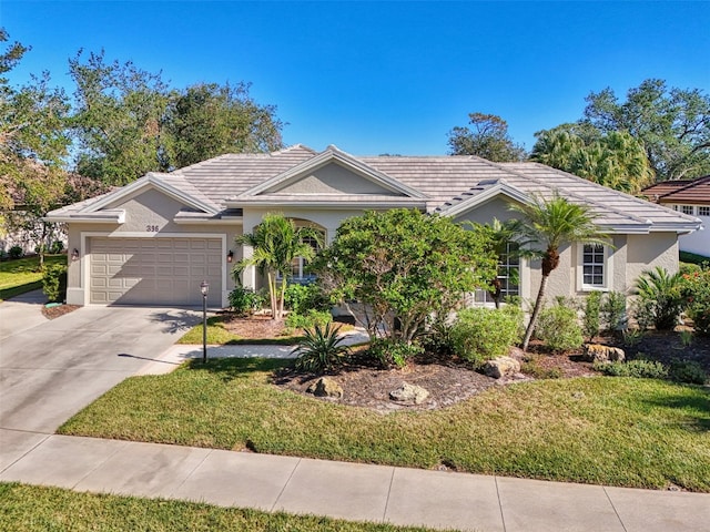 single story home with a garage, concrete driveway, and a front yard