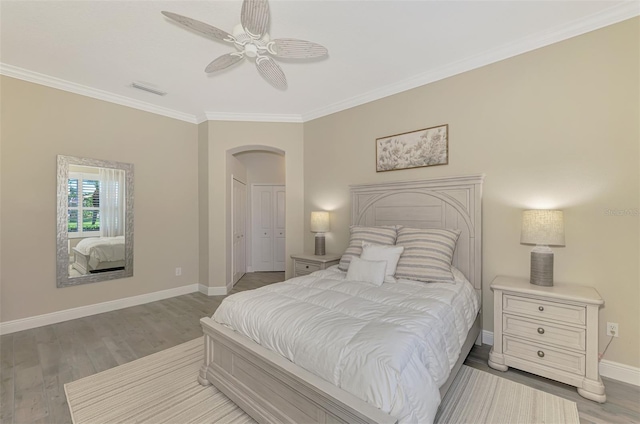 bedroom with ceiling fan, crown molding, and light wood-type flooring