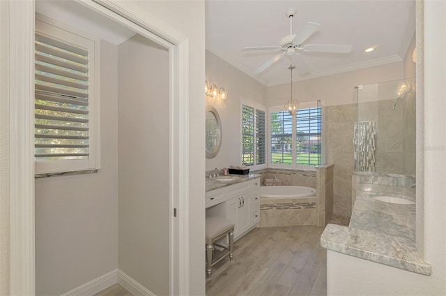 bathroom with ceiling fan, hardwood / wood-style floors, shower with separate bathtub, vanity, and ornamental molding