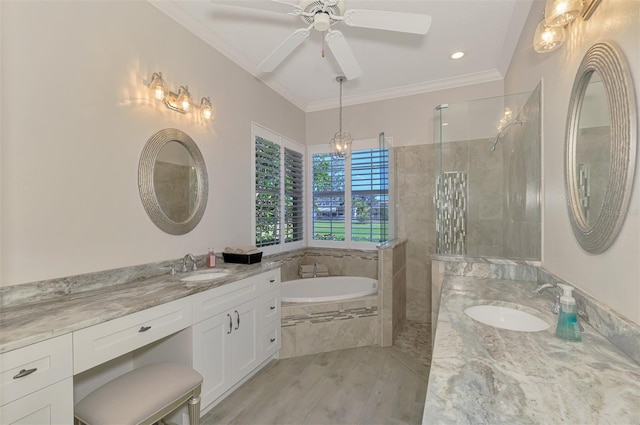 bathroom featuring ornamental molding, vanity, ceiling fan, wood-type flooring, and shower with separate bathtub