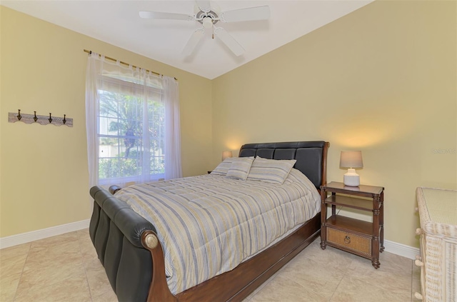 tiled bedroom featuring ceiling fan