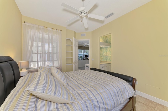 tiled bedroom with ceiling fan and multiple windows