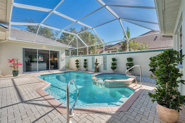 view of swimming pool with a lanai, an in ground hot tub, and a patio