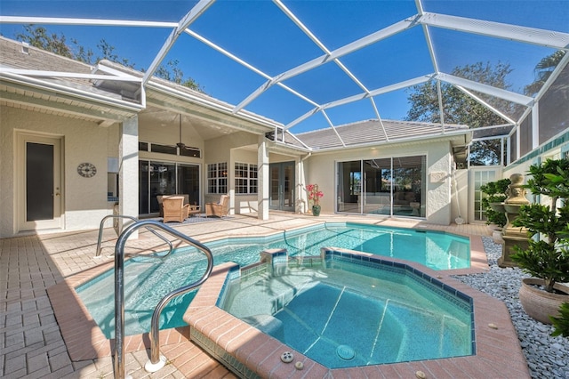 view of pool featuring an in ground hot tub, a lanai, and a patio area