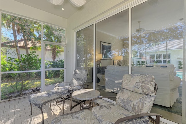 sunroom / solarium with ceiling fan and a healthy amount of sunlight