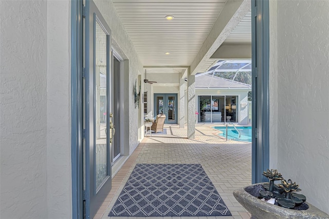 exterior space featuring a lanai, an outdoor pool, and french doors