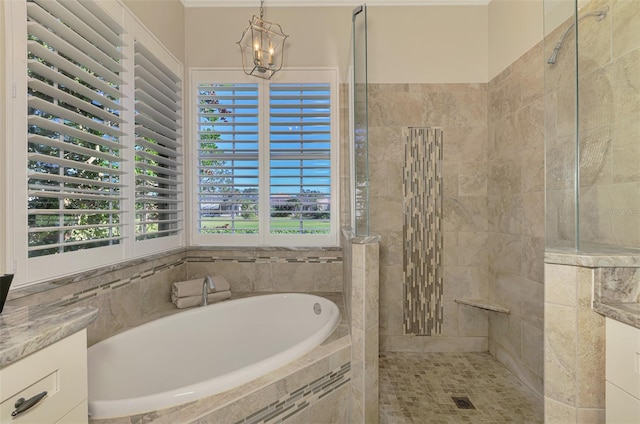 full bath featuring a walk in shower, a garden tub, and a notable chandelier