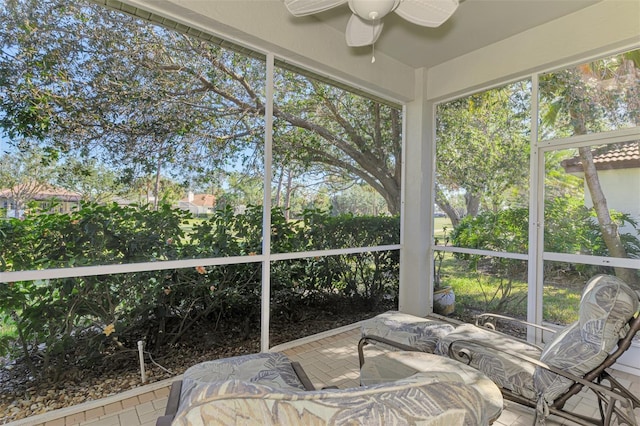 sunroom / solarium with a ceiling fan and a healthy amount of sunlight