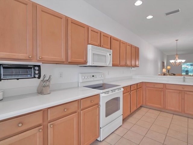 kitchen featuring white appliances, sink, light tile patterned floors, pendant lighting, and a chandelier