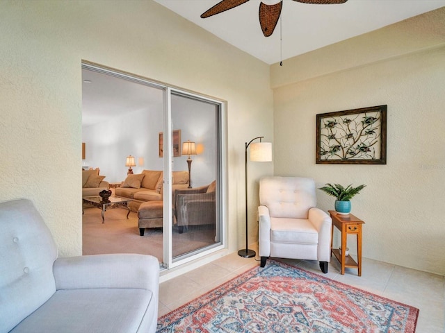 sitting room with light tile patterned floors and ceiling fan