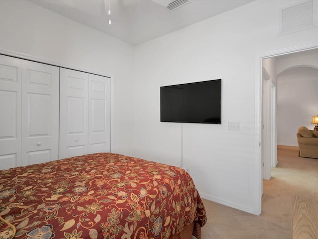 4181 Lenox Blvd, Venice, FL 34293 - bedroom featuring light colored carpet, arched walkways, a closet, and baseboards